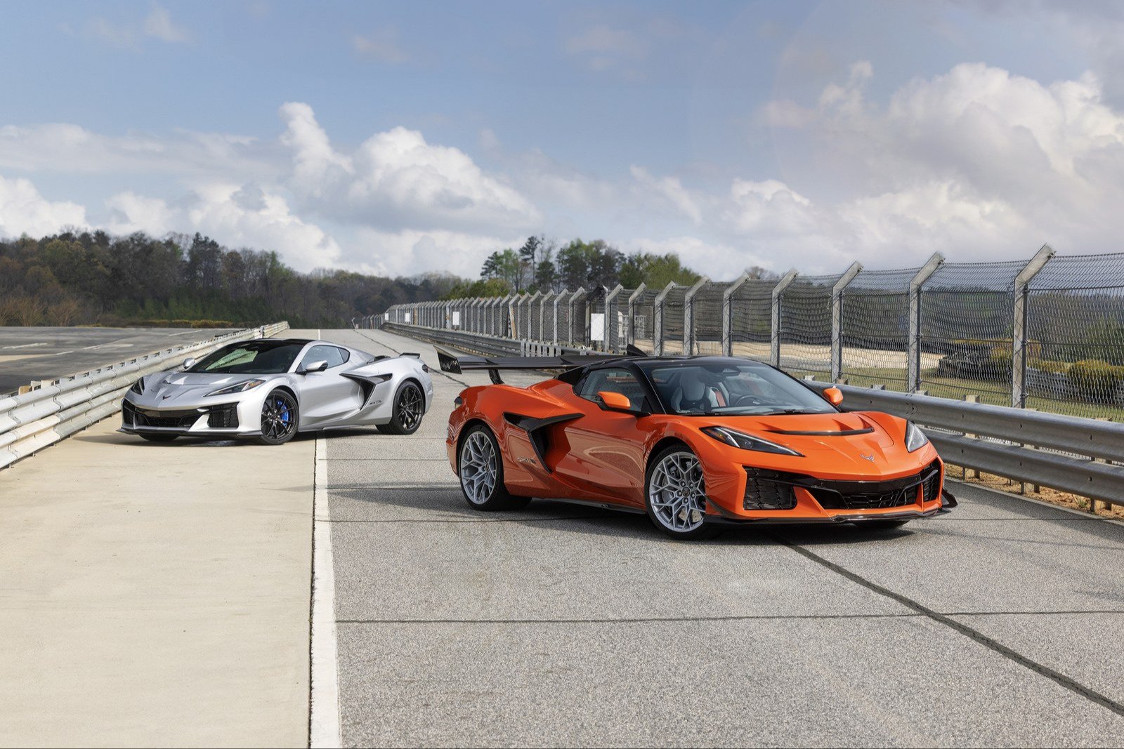 Silver Corvette ZR1X coupe and orange ZR1X convertible on a track