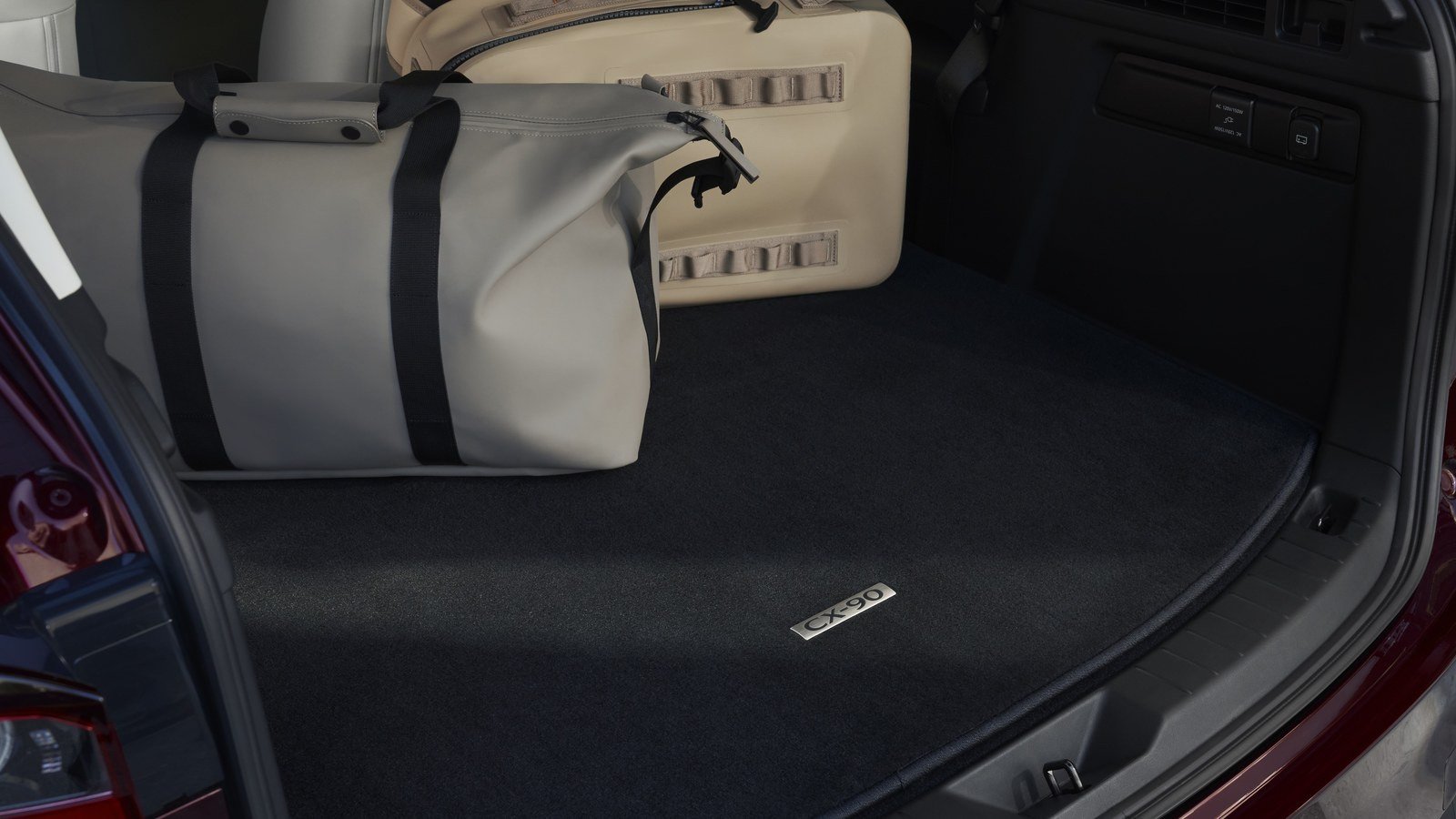 Mazda CX-90 cargo area with luggage and CX-90 cargo mat