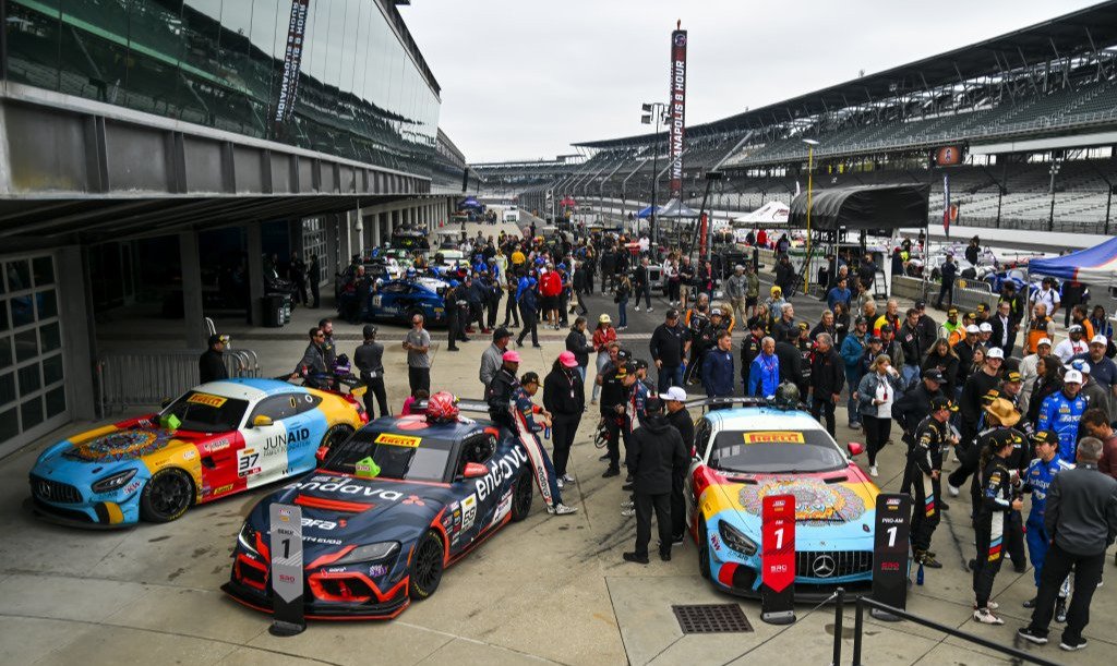 Class-winning GT4 cars parked in victory lane at Indianapolis