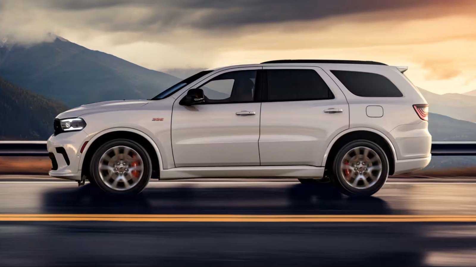 White Dodge Durango side profile on a mountain road