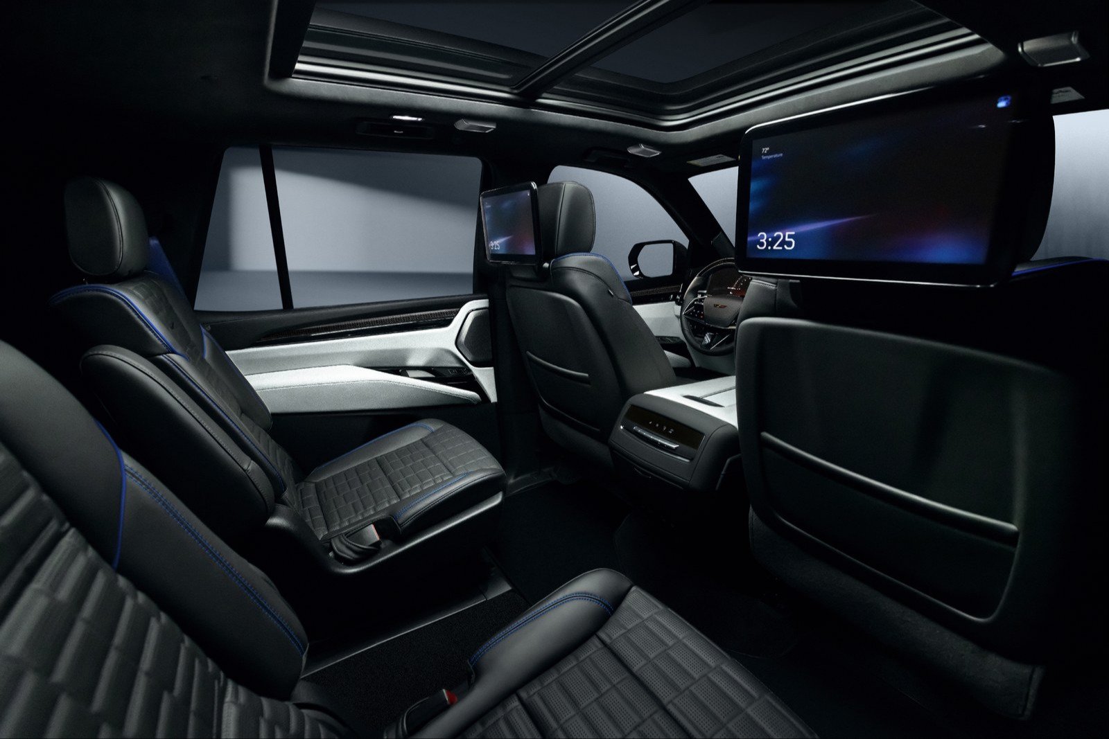 Black and gray Escalade-V cabin with blue stitching and rear screens