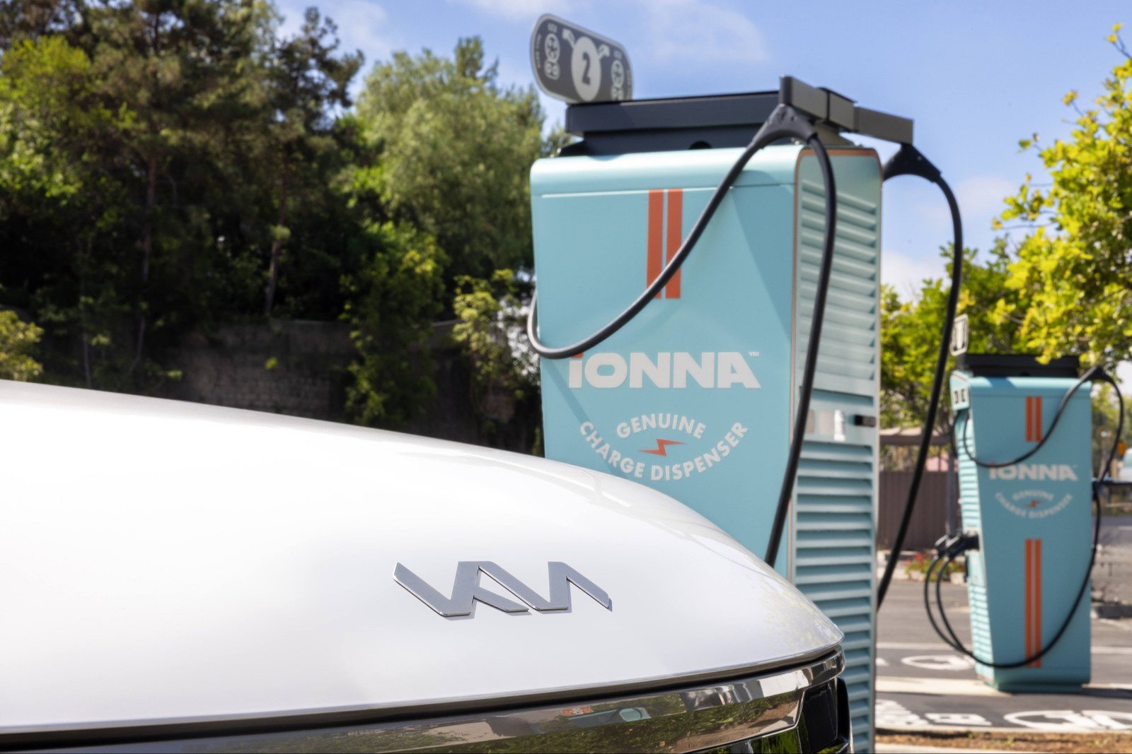 White Kia EV9 charging at an IONNA charge dispenser