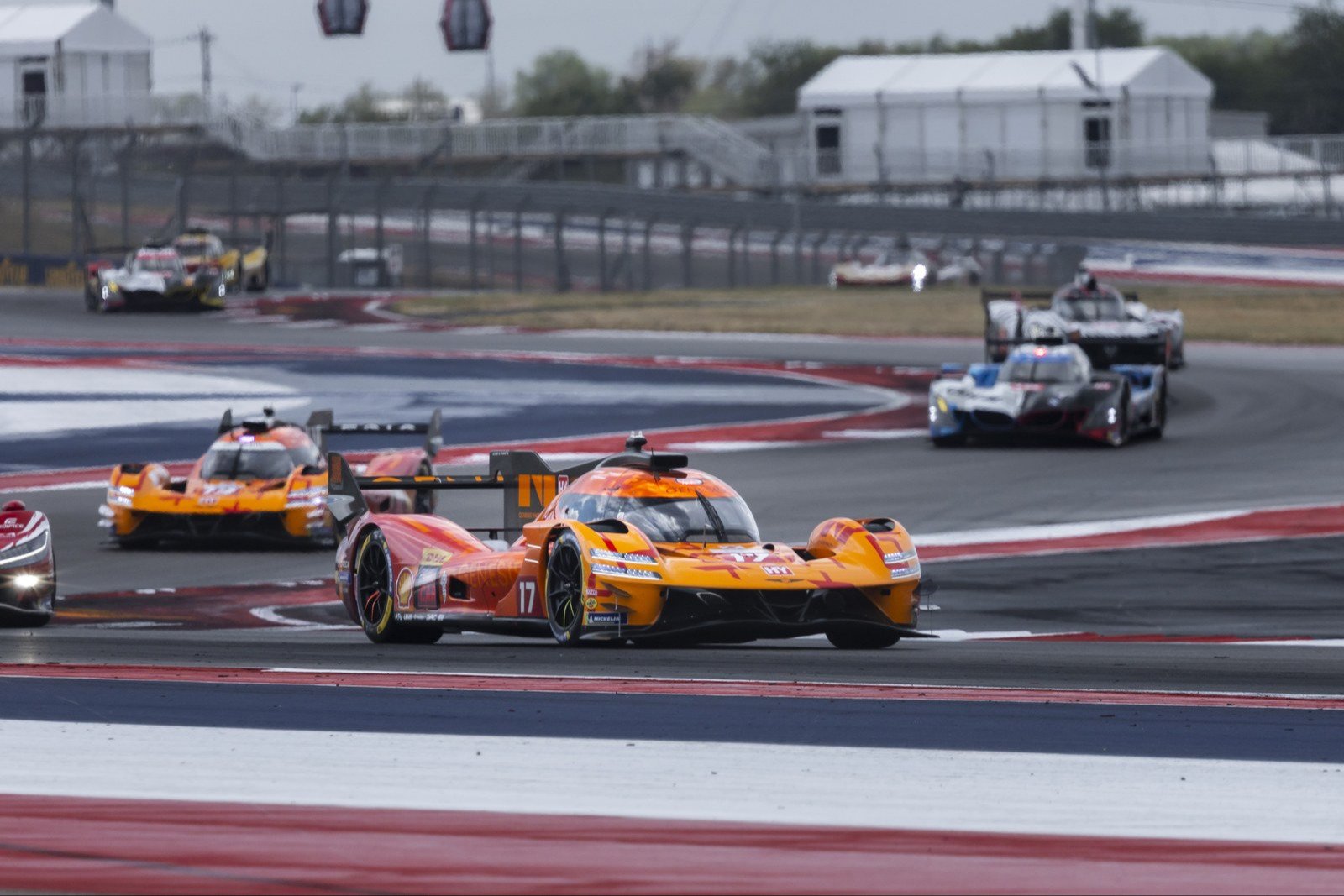 Orange Genesis GMR-001 #17 Hypercar cornering at Circuit of the Americas
