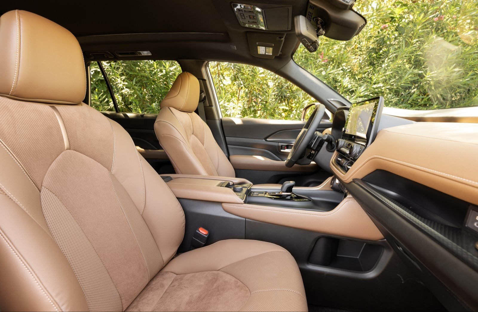 Tan leather front seats and dashboard of a Toyota Grand Highlander Hybrid MAX Platinum