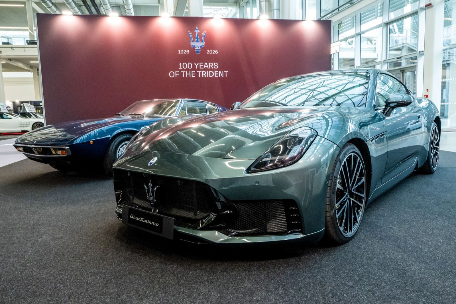 Green Maserati GranTurismo Trofeo with a blue Ghibli behind it