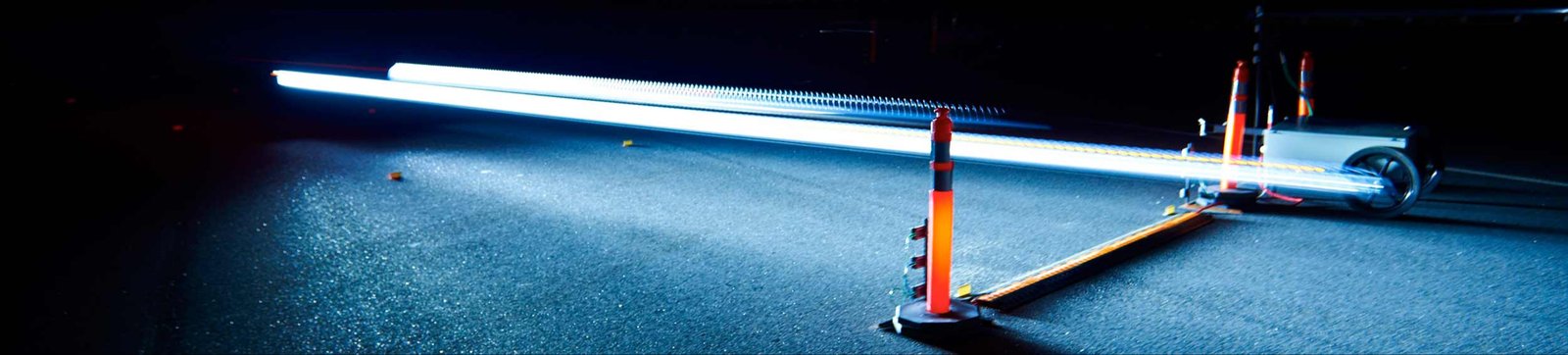 Light sensors on the IIHS test track capture a passing headlight beam at night