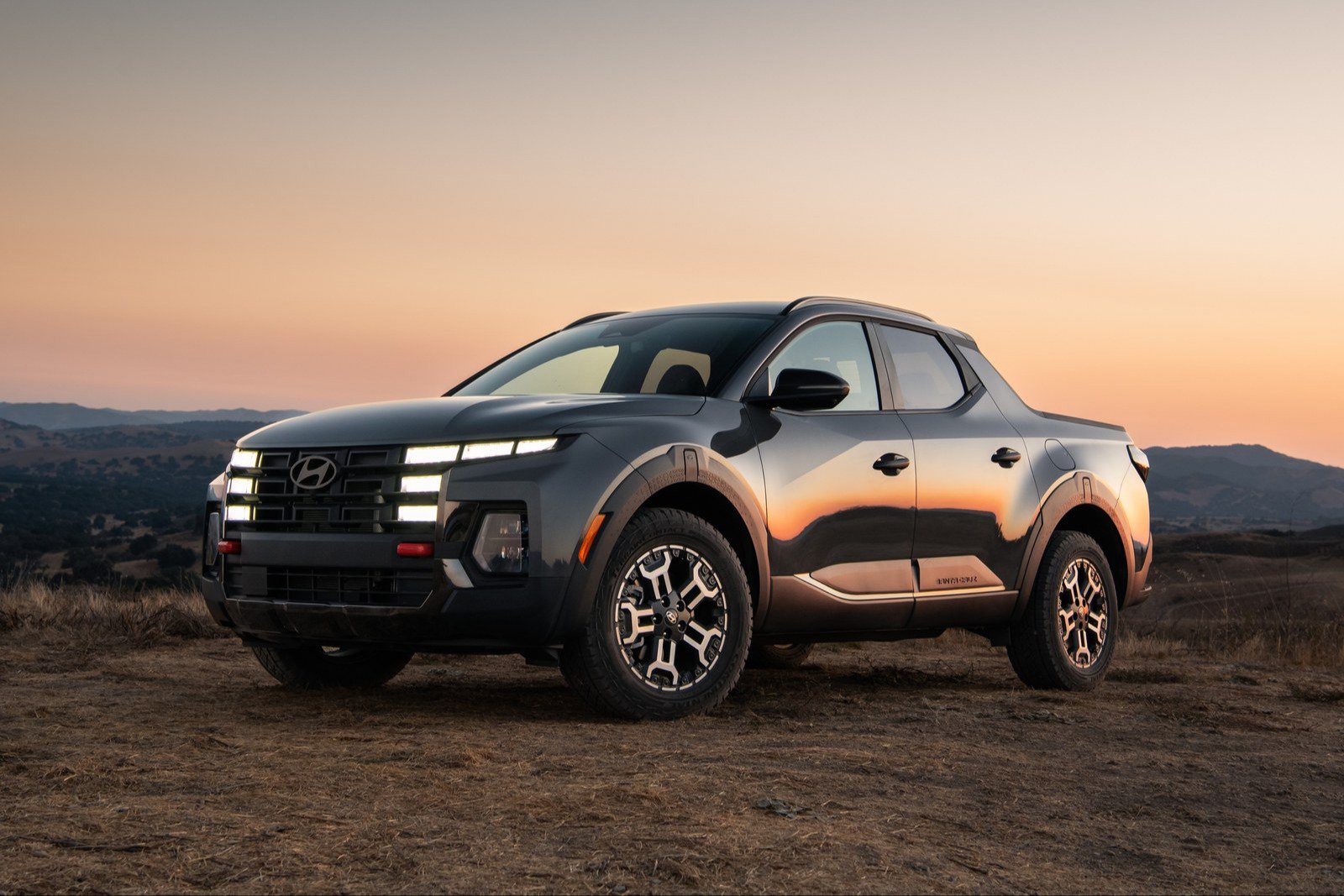 Gray Hyundai Santa Cruz XRT parked on a hilltop at dusk