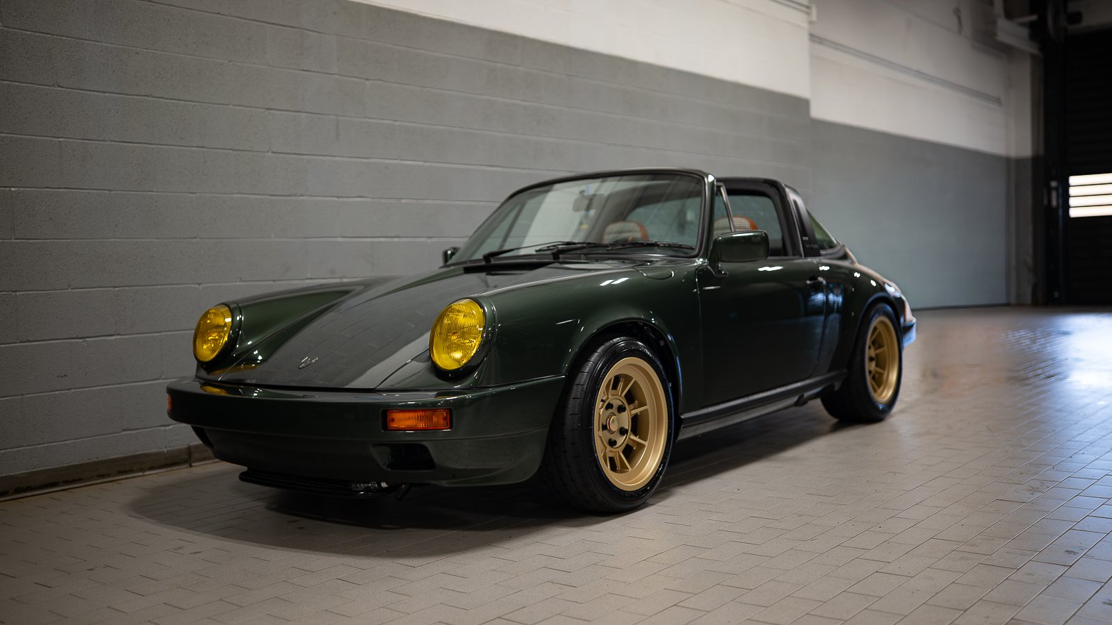 Oak Green 1980 Porsche 911 SC Targa with yellow headlights and gold wheels