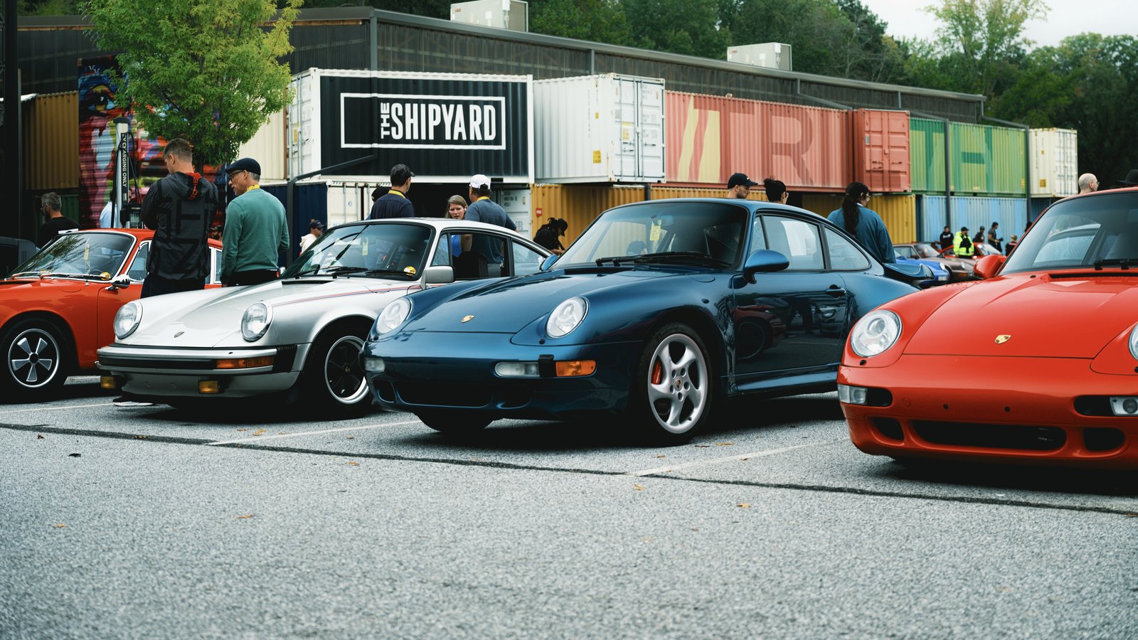 Classic Porsche 911s parked in front of The Shipyard at Trilith