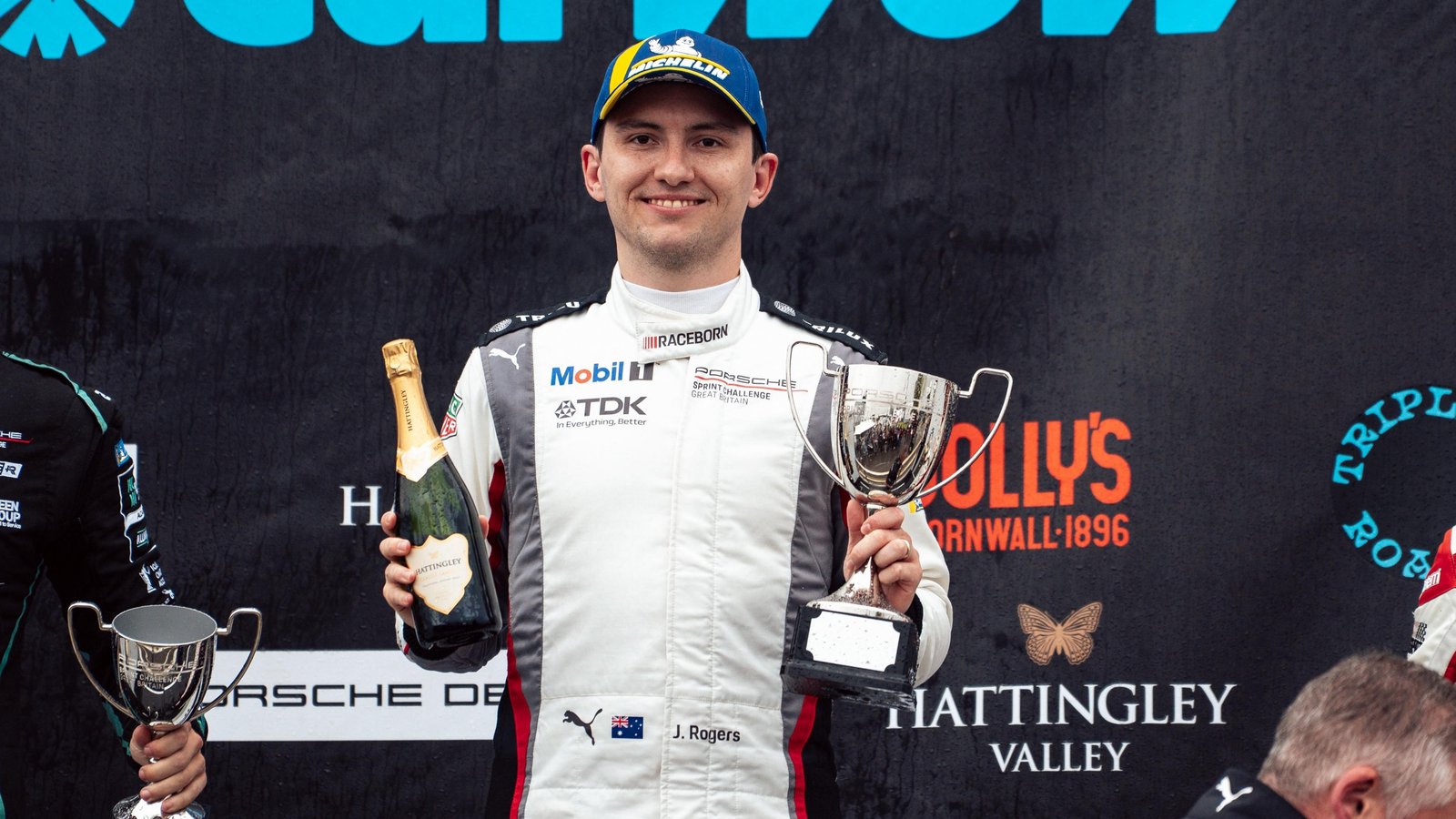 Joshua Rogers on the podium with trophy after a Porsche Sprint Challenge GB win