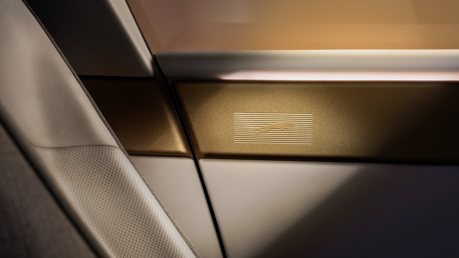Brass-finish trim with the Jaguar leaper inside the Type 01