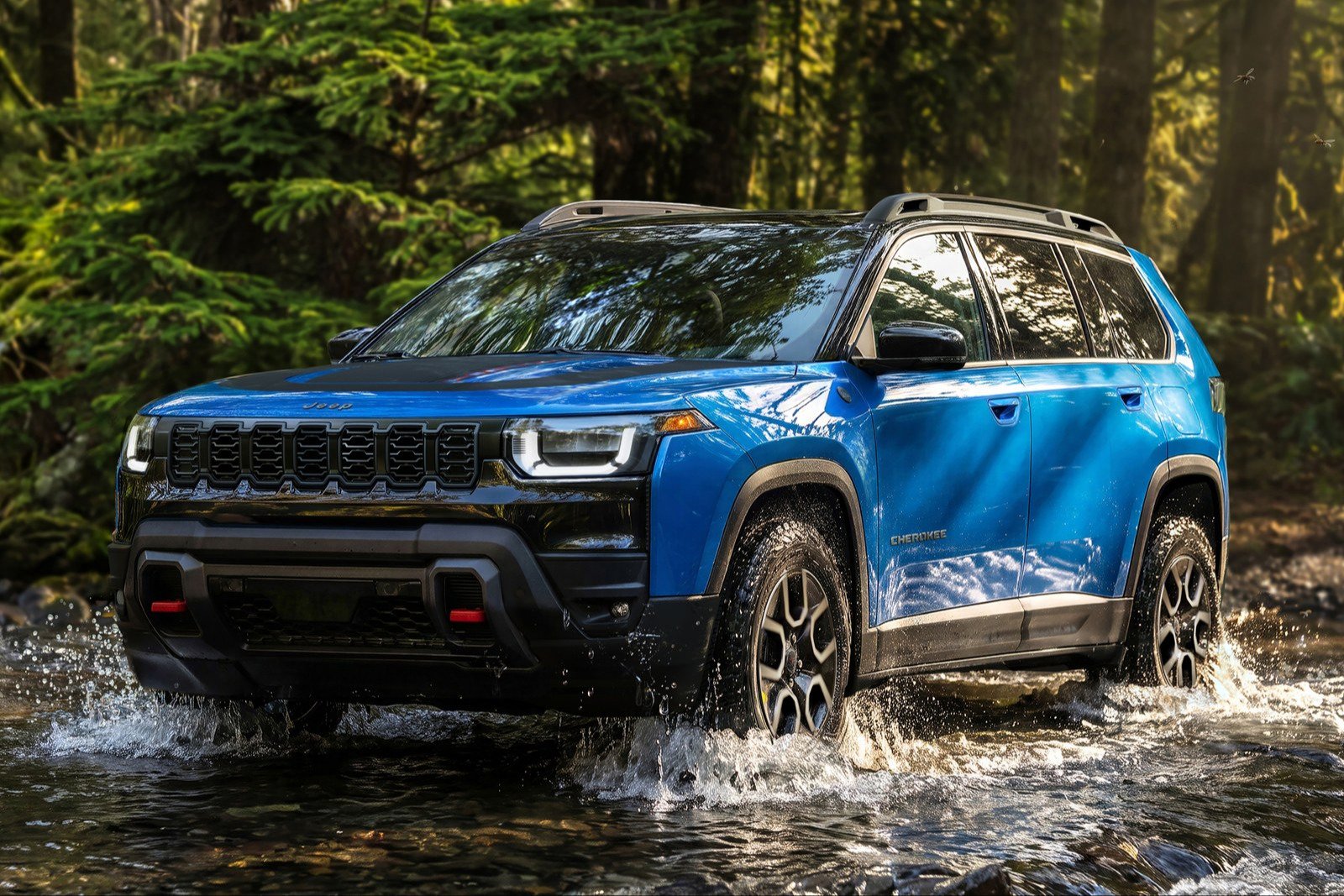 Blue 2027 Jeep Cherokee Trailhawk fording a shallow stream