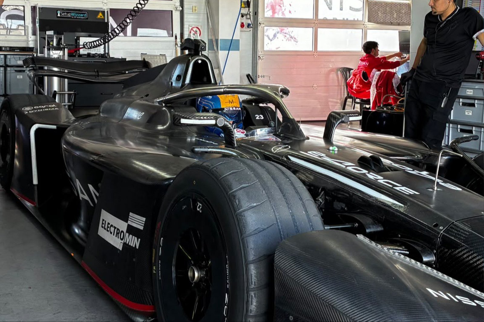 Maloney seated in the Nissan GEN4 car in the garage