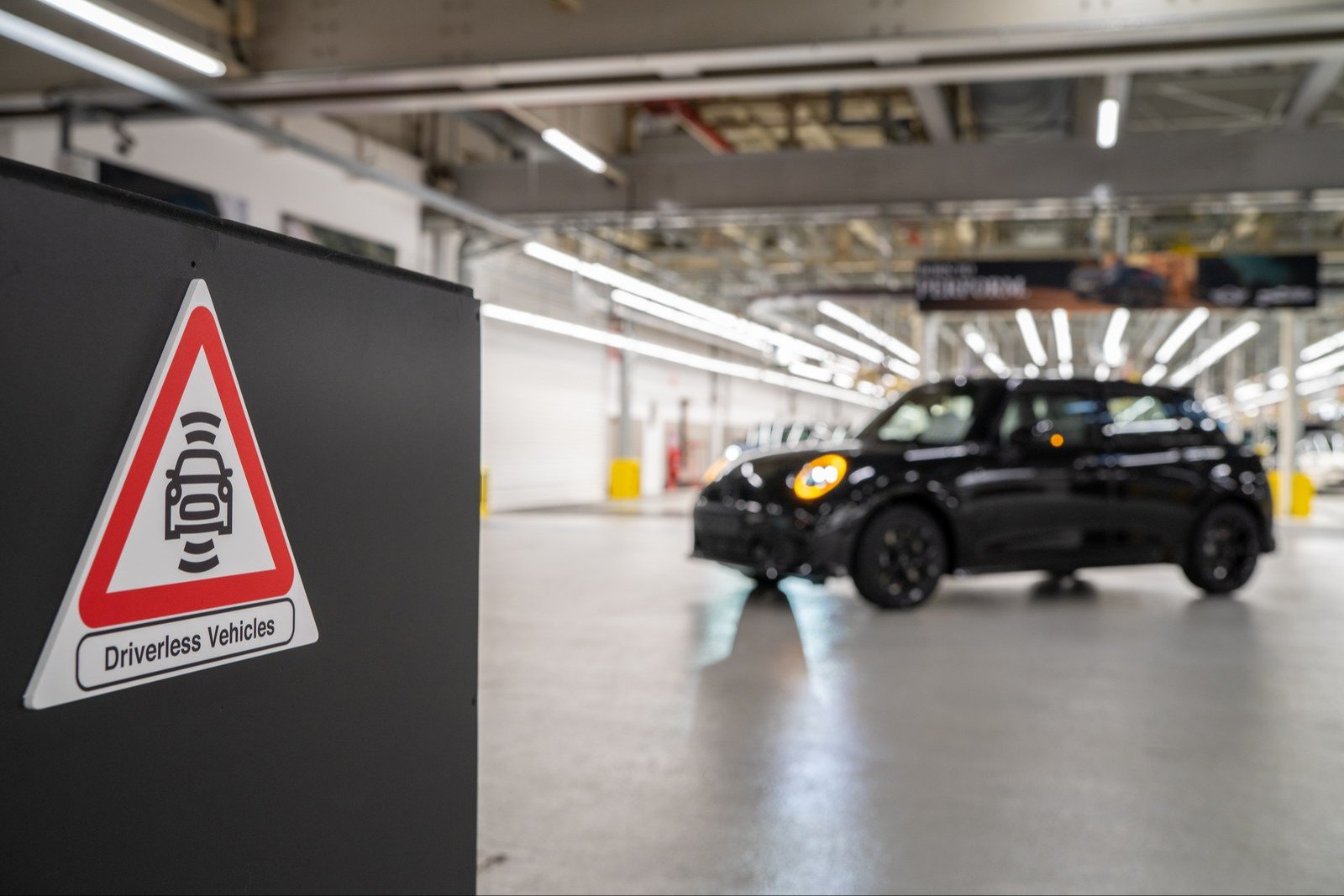 Driverless Vehicles warning sign with a black MINI behind it