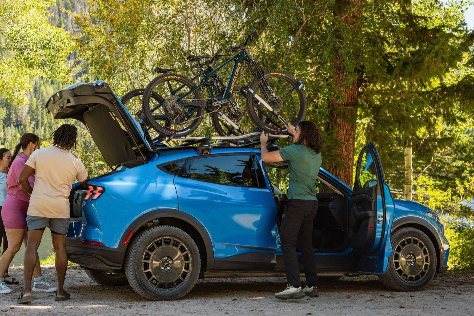 Blue Ford Mustang Mach-E Trail with bikes loaded on roof