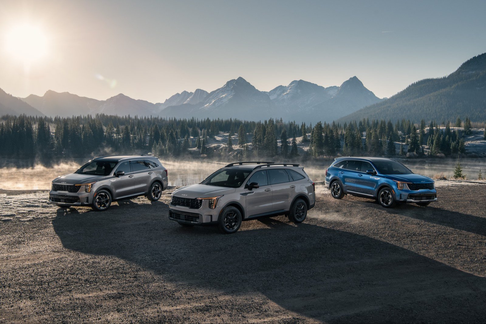 Three 2027 Kia Sorento models parked in front of mountains