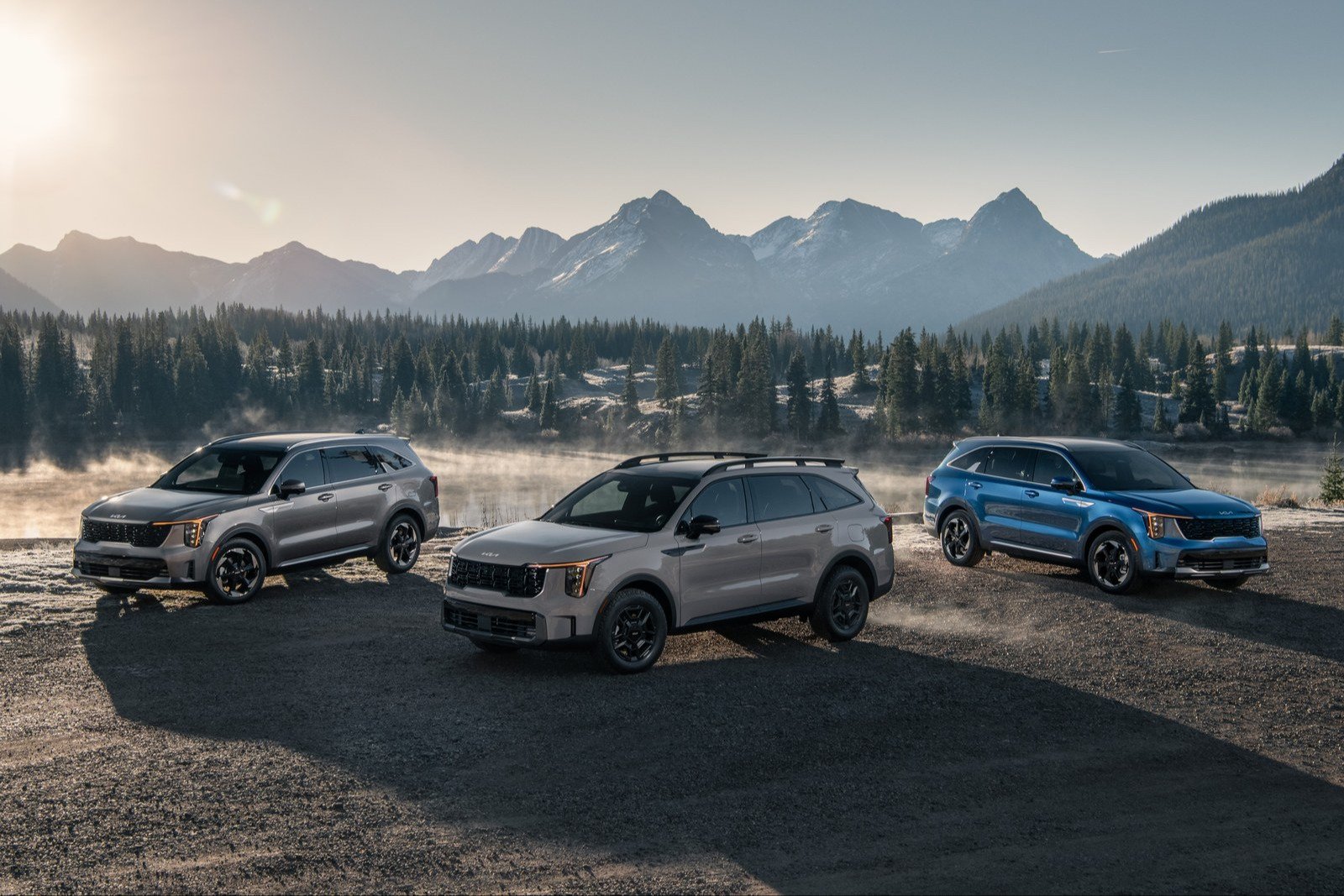 Three 2027 Kia Sorento SUVs parked in front of mountains