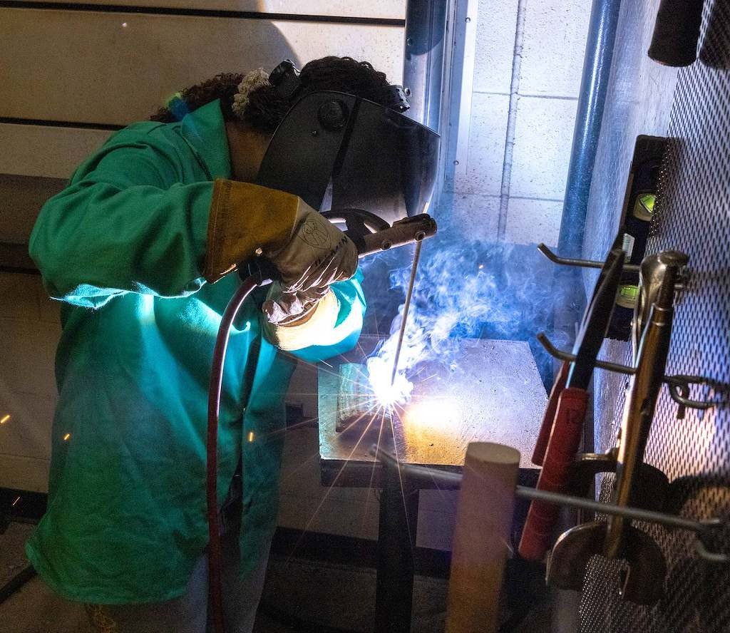 Student welding in a school workshop