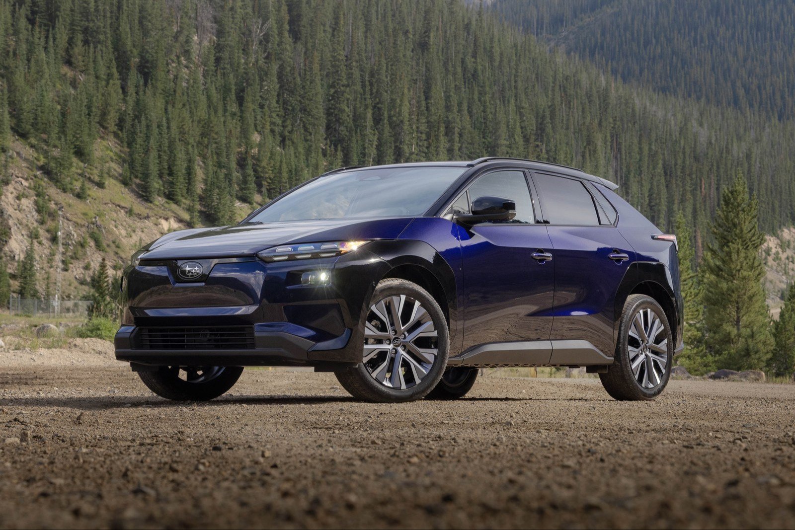 Dark blue 2026 Subaru Solterra on a gravel road in the mountains