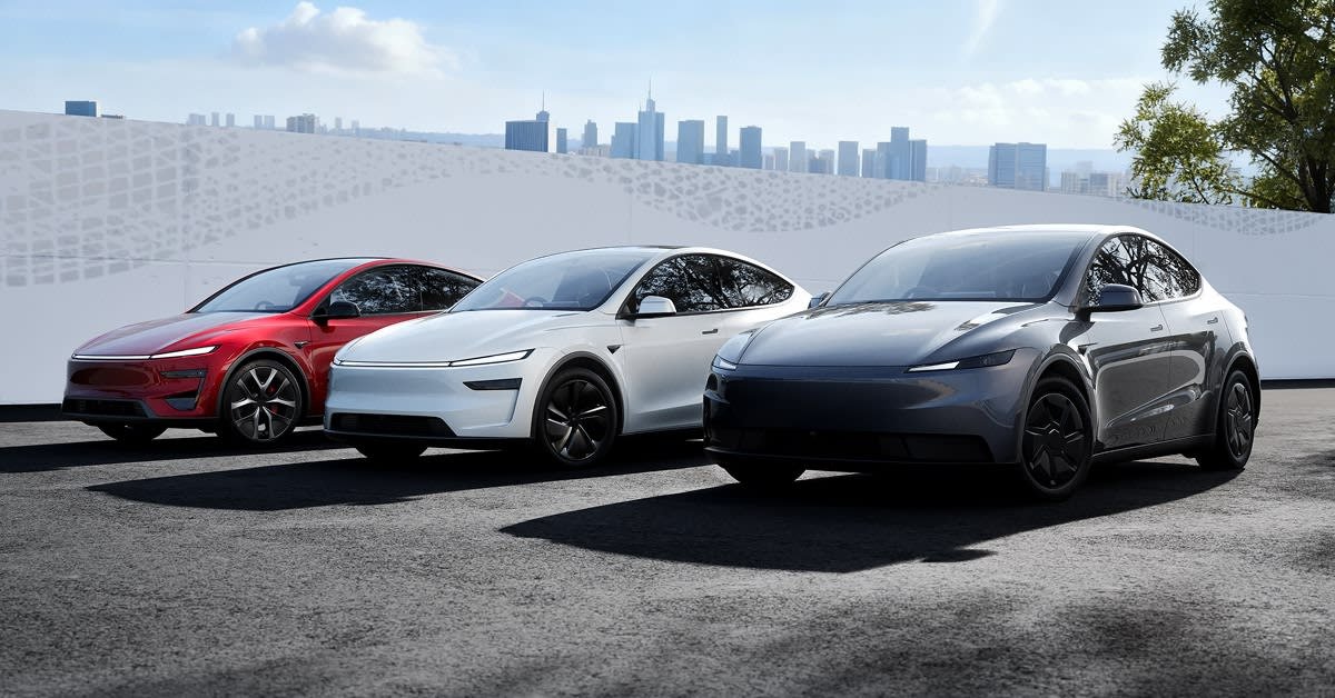 Three Tesla Model Y crossovers in front of a city skyline