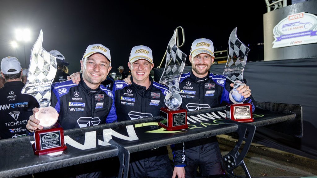 Russell Ward, Philip Ellis, and Indy Dontje hold Petit Le Mans trophies