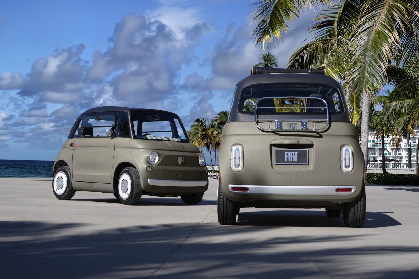 Two greige Fiat Topolino microcars on a seaside road