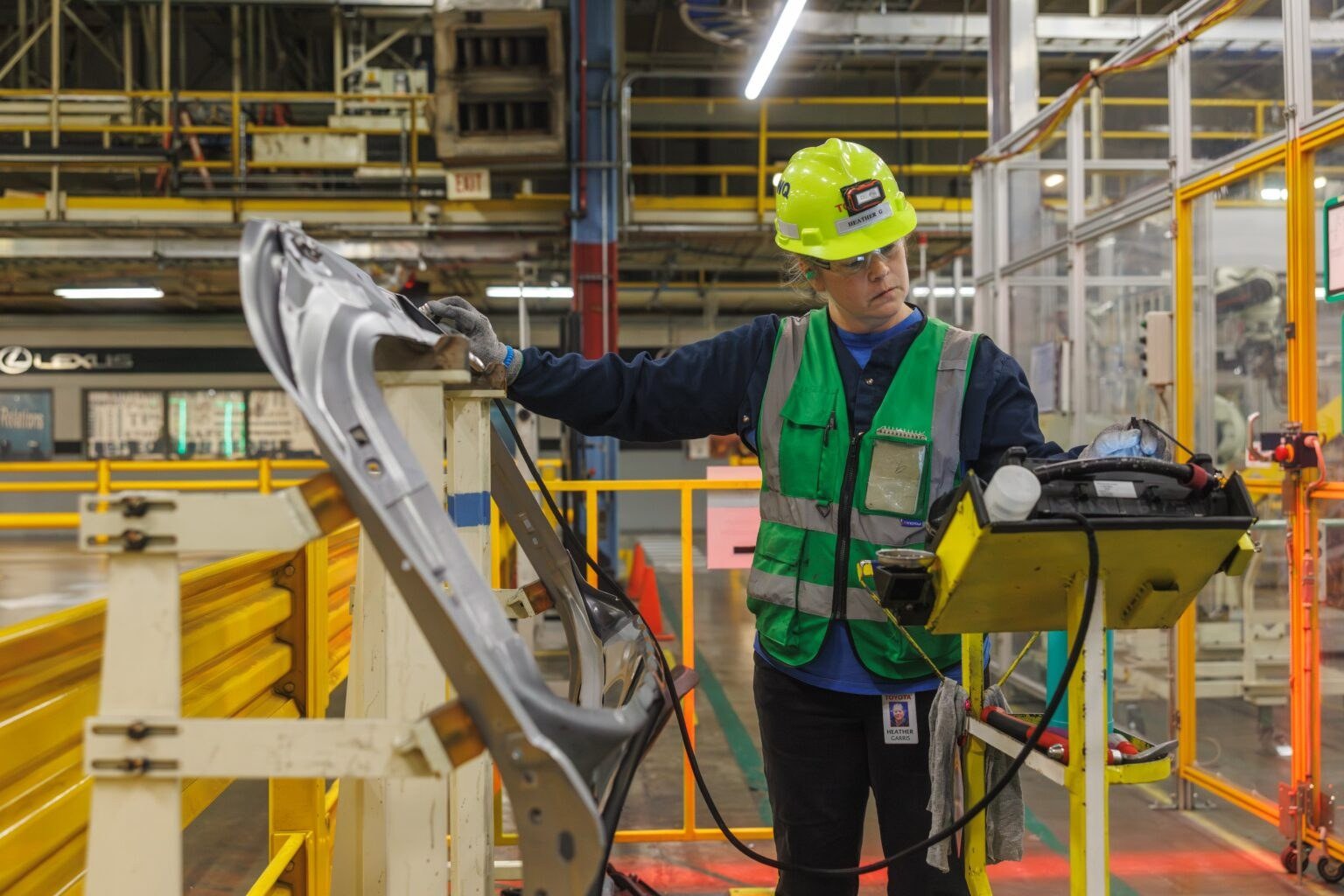 Toyota team member inspecting a door assembly at a check station
