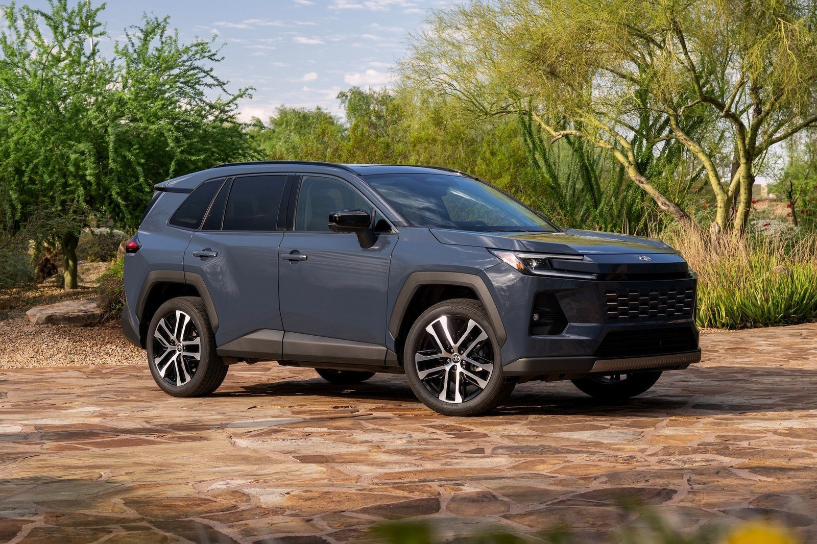 Gray 2026 Toyota RAV4 Hybrid Limited parked on a stone patio