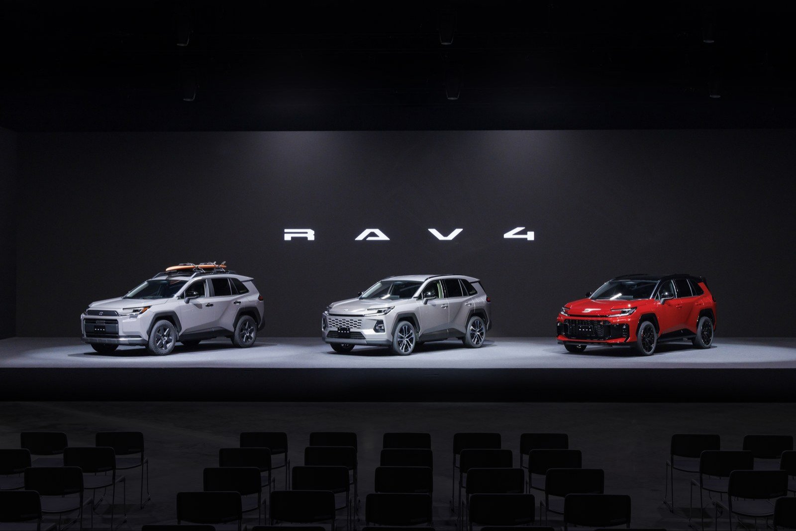 Three sixth-generation Toyota RAV4 prototypes on a stage: Woodland, CORE, GR SPORT