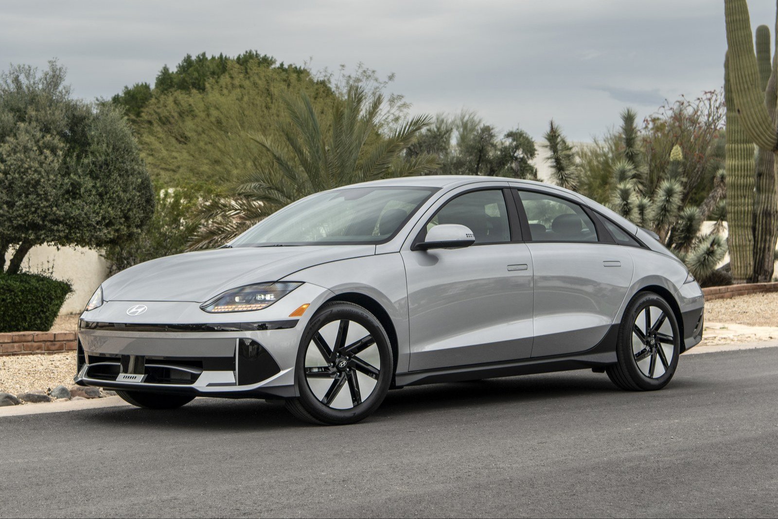 Silver 2024 Hyundai Ioniq 6 SE sedan parked by desert plants